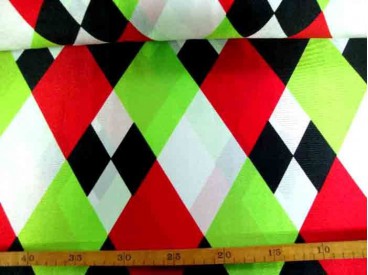 Een glanzende carnavals stof met gekleurde wiebertjes. 100% polyester  1.50 mtr. breed