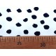 Een witte tricot met zwarte vlekjes. Oekotex stoffen, 95% katoen/5% elastan 1.50 mtr.breed