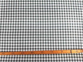 Een met donkergrijze boerenbont ruit bedrukte canvas, die iets wat stug aanvoelt.  Het ruitje is 7 x 7 mm. 100% katoen 1.50 mtr.