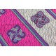 Afrikaanse wax stof. Schuine banen en grote ornamenten. O.a. paars zand en pink
