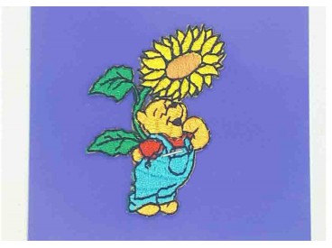 Een Winnie the Pooh applicatie,  met een afmeting van  6 x 4.5 cm.   Opstrijkbaar. Winnie staand onder de zonnebloem.           