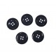Zwarte kunststof knoop 4- gaats  Glanzend zwart met een opstaande rand.  22 mm doorsnee