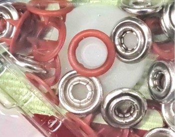 Babydrukkers. Rode inslag baby drukknopen met werktuig. Een open rondje. Doorsnee 9.7 mm. 15 stuks per pakje