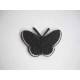 Een opstrijkbare vlinder applicatie van 5 x 3.5 cm. Zwart