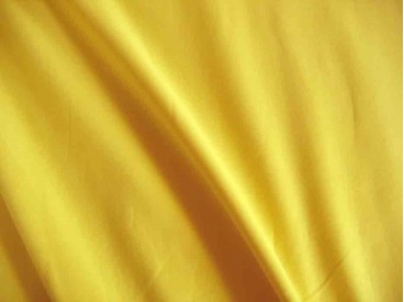 Mosterd kleurige viscose tricot.  92%visc./8%el.  1.60 mtr.br  225 gr/m²