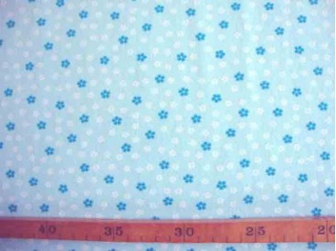 Een lichtblauwe bedrukte tricot met een petrol/witte minifleur. Rekt in de breedte en in de lengte 95%co/5%el. 1.50 mtr. br.